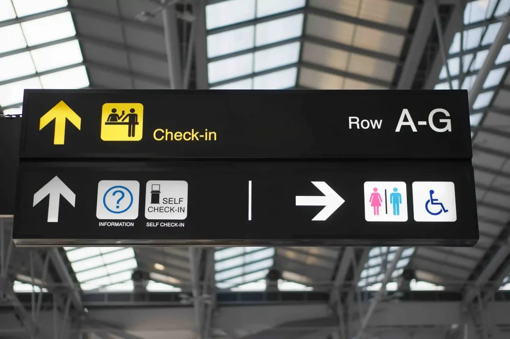 Check-in row and self check-in signage at Bali Ngurah Rai International Airport