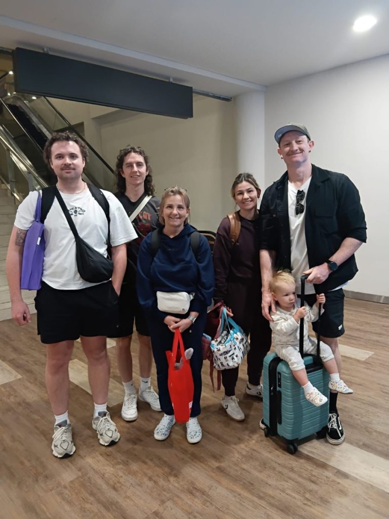 Group of guests arriving at Bali airport with luggage trolleys