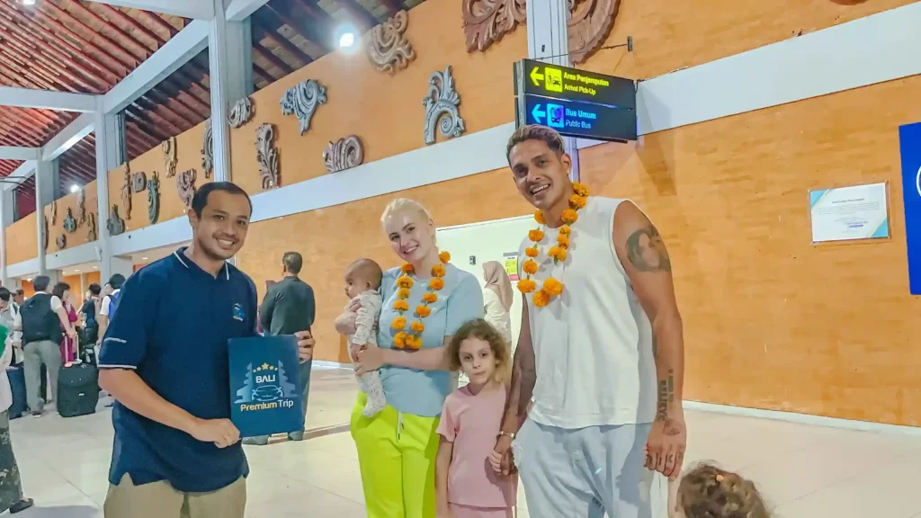 Family welcomed with flower garlands by a Bali Meet and Greet agent at Ngurah Rai International Airport